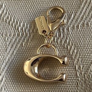 Gold Toned Signature C Zipper Pull Charm.